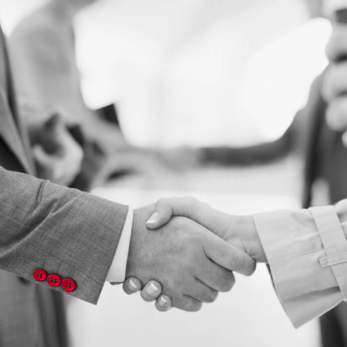 Man and woman shaking hands Atradius Collections